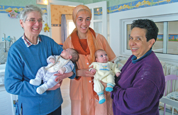 Babies get plenty of love from Sister Agnes Perrin, N.D.S., Feten, a local childcare worker, and Sister Araceli Medina, N.D.S. 