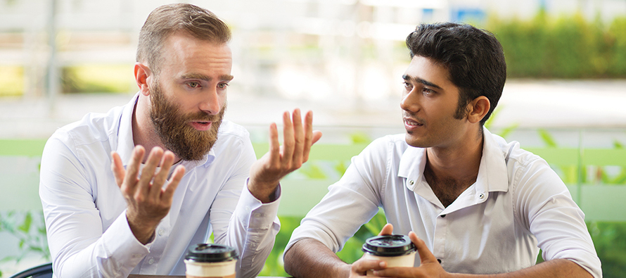 Two men talking over coffee